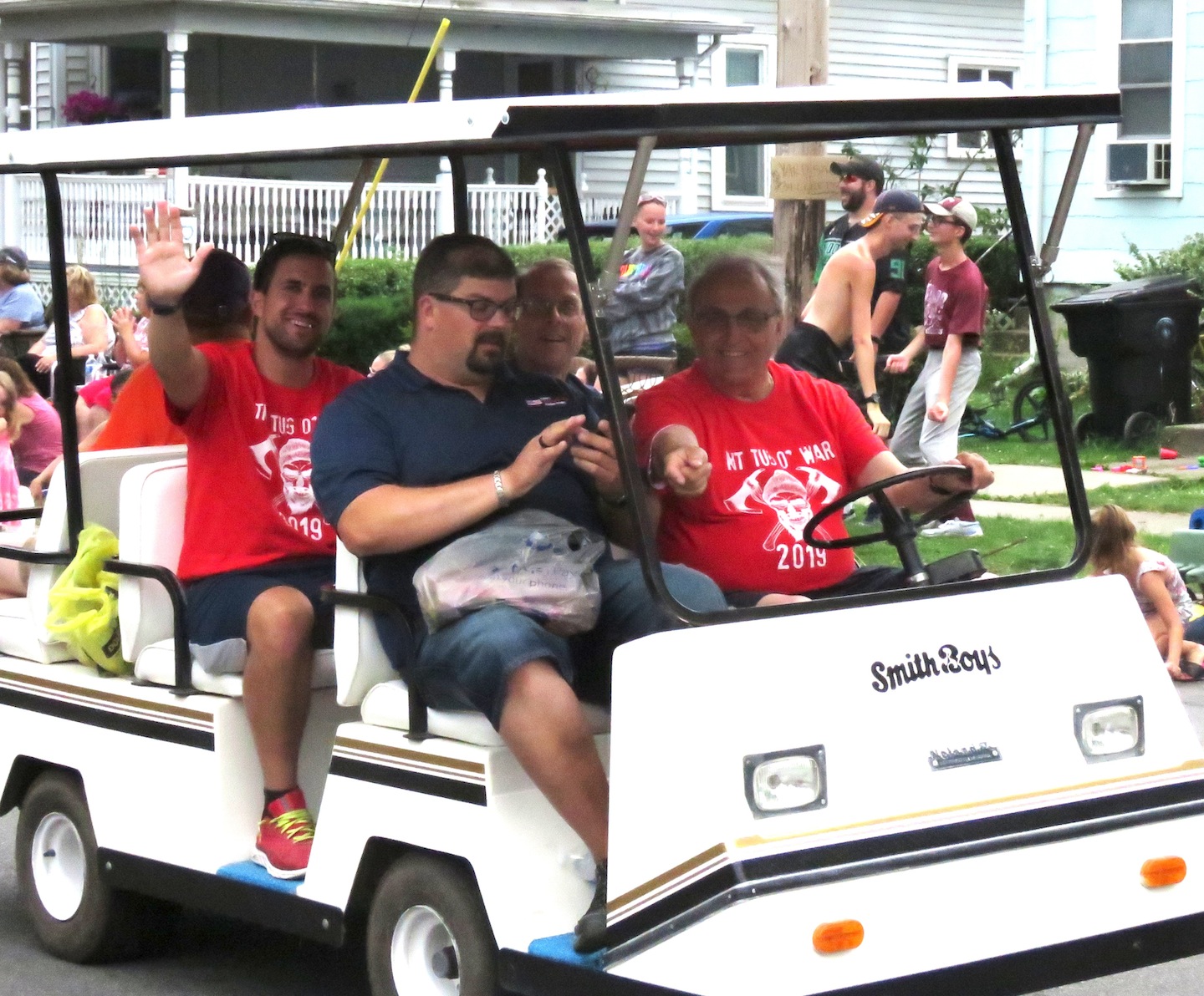Above, North Tonawanda city officials -- Mayor Arthur Pappas (driving), Common Council President Eric Zadzilka (passenger seat), Alderman Mark Berube (back seat, at right) and Administrative Assistant Dan DiVirgilio (back seat, at left) -- stroll through the Canal Fest Parade in a golf cart. Pappas and NT officials were happy campers, as the North Tonawanda side won the tug-of-war battle, earlier in the day. 